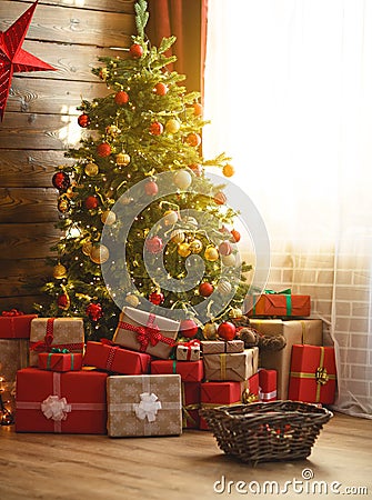 Interior christmas. magic glowing tree, fireplace, gifts Stock Photo