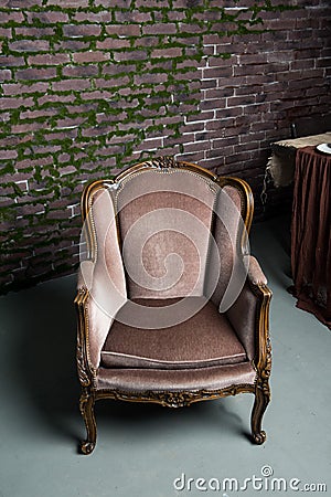 Interior. Classic chair. Brick wall background. Stock Photo