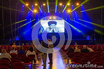 interior of the concert hall at the Altice Arena in Lisbon On the stage screen a young actor acting out an expression of boredom Editorial Stock Photo