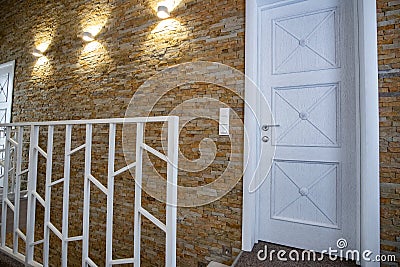 Interior of a contemporary home with spacious hallway, room doors and staircase railing in modern style Stock Photo