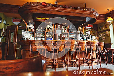 Interior of costly stylish bar, made of mahogany in the Irish pub. Stock Photo