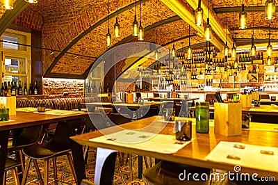 Interior of cozy modern restaurant with bar counter and lamp lighting Editorial Stock Photo