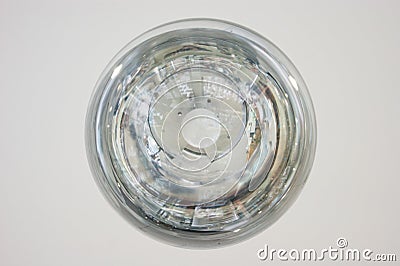 The interior design element of a huge store is the original form of transparent round glass ball-lamps of silver color Stock Photo
