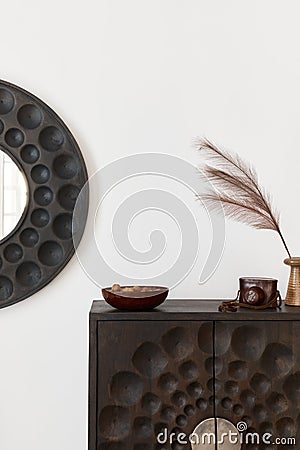 Interior design of ethnic living room with modern commode, round mirror, decoration, furniture and personal accessories. Template Stock Photo