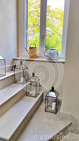 Interior design, stairs, window, candles, teapots Stock Photo