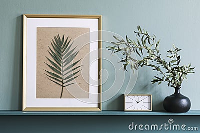 Stylish living room with mock up photo frame on the green shelf. Stock Photo