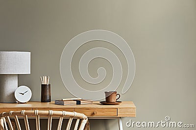 Interior design of neutral bohemian living room interior with stylish desk, armchair, lamp decoration, office supplies, clock. Stock Photo