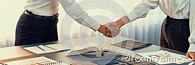 Interior designer shake hand after making successful house design. Insight Stock Photo