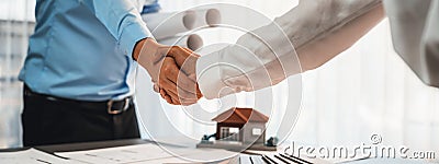 Interior designer shake hand after making successful house design. Insight Stock Photo