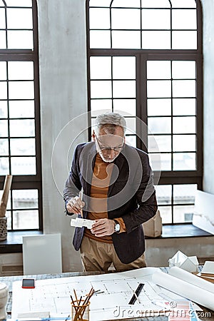 Interior designer wearing nice hand watch looking at sketches Stock Photo