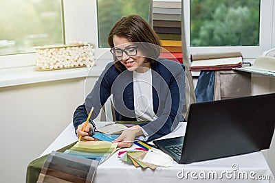Interior designer, at the workplace in the office with samples o Stock Photo