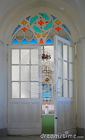 Interior door and stained glass window in the Lutheran church Editorial Stock Photo