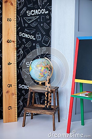 Interior of elementary school. Chalkboard, Books, globe and stationery on classroom. Teachers Day concept. Back to school. Empty c Stock Photo