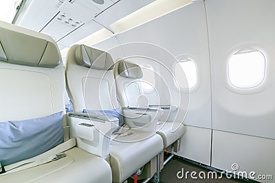 Interior of empty ready to fly airliner cabin with rows of seats Stock Photo