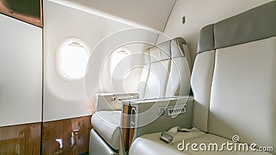 Interior of empty ready to fly airliner cabin with rows of seats. Stock Photo