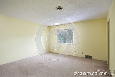 Interior of an empty renovated yellow and white room with a window Editorial Stock Photo