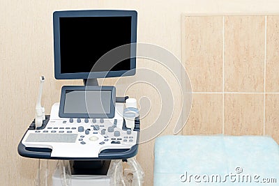 Interior of examination room with ultrasonography machine in hospital laboratory. Modern medical equipment background. Stock Photo
