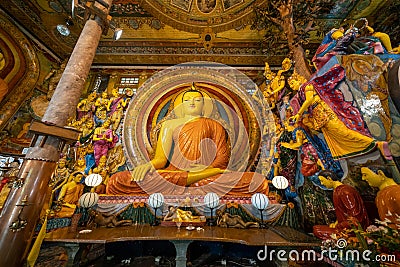 Colombo, Sri Lanka - November 19, 2019: Interior of Gangaramaya Buddhist Temple with large Buddha statue and shrine Editorial Stock Photo