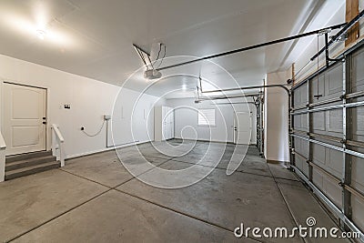 Interior of a garage with double automatic doors and concrete floor Stock Photo