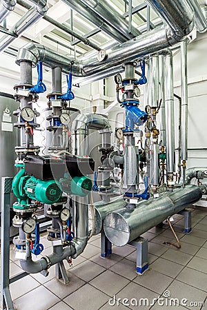Interior gas boiler room with multiple pumps and piping Stock Photo
