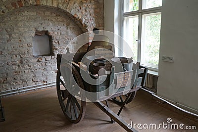 A horse cart with accessories for repairing and cleaning stoves is in the Gothic House in the old town of Spandau. Editorial Stock Photo