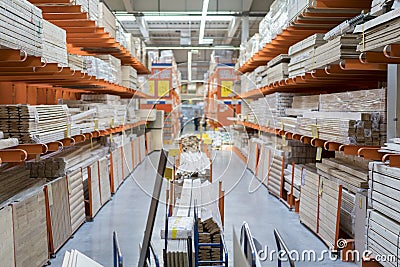 interior of hardware retailer with aisles, shelves, racks of building material insulation floor to ceiling. Stock Photo