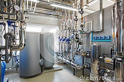 The interior of an industrial boiler house with a multitude of p Stock Photo