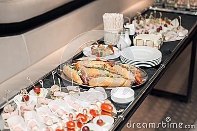 Interior inside the limousine. with sofas and a table covered with snacks for the holiday. Selective focus Stock Photo