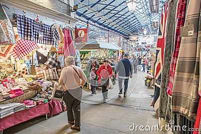 Interior inside of market hall showing a variety of stalls vendors and customers browsing Editorial Stock Photo