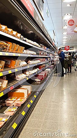 Interior inside view of an Aldi supermarket shop store showing food for sale on display in chillers Editorial Stock Photo