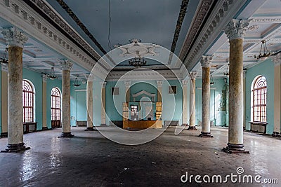 Interior of large column hall with fretwork at abandoned mansion Stock Photo