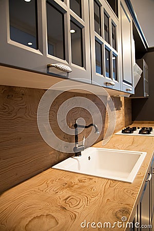 Interior of luxurious wooden modern kitchen grey cabinets Stock Photo