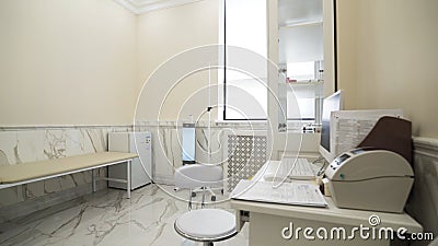 Interior of a medical cabinet at the hospital. Action. Empty medical room with couch for patients and medical equipment. Stock Photo