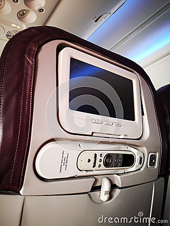 Closeup interior of mini television on flight for passengers on seats inside airplanes view. Stock Photo