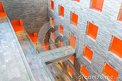 Interior modern building with several floors and orange painted passages Editorial Stock Photo