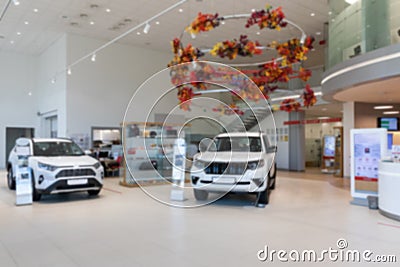 interior of a modern car dealership with white SUVs, premium showroom, photo with blur Stock Photo