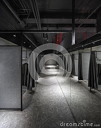 Interior of modern clothes shop with fitting room Stock Photo