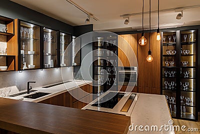 Interior of modern kitchen with glass cabinets and decorative bulbs Stock Photo