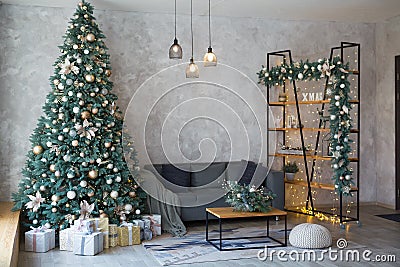 Interior of modern living room with comfortable sofa decorated with Christmas tree and gifts Stock Photo