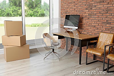 Interior of modern office with packed belongings Stock Photo