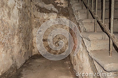Interior of an old abandoned house with ruined walls and stairs Stock Photo