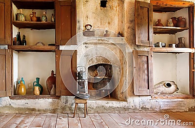 Interior of old house in Georgia country, with kitchen utensils, kettle, primus, fireplace and wooden floor Editorial Stock Photo