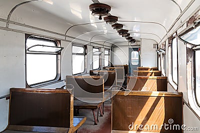 Interior of an old passenger car on a railroad. Historic vintage train Slightly left angle. Rows of seats and old style furnishing Stock Photo