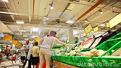 Interior of ordinary grocery section with customers stock video footage Interior of ordinary grocery section with customers stock video footage