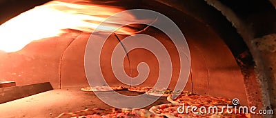 interior of an oven of Italian pizzeria with pizzas cooking Stock Photo