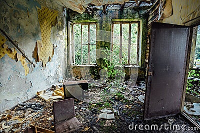 Interior of overgrown room of abandoned and forsaken apartment house Stock Photo