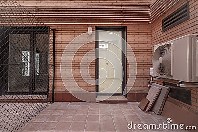 Interior patio of a house with a separating metal fence Stock Photo