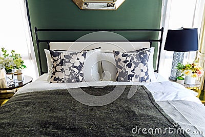 An interior picture of a bed with many pillow with a black black Stock Photo