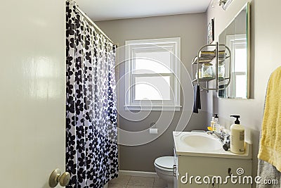 Interior of a renovated bathroom with a floral shower curtain Editorial Stock Photo