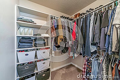 Interior of residential home walk in closet with built in open storage shelves Stock Photo